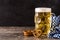 Oktoberfest beer with pretzels on wooden table.