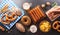 Oktoberfest festival decoration symbols made from Pretzel loaf, beer, sausage, potato chips and Bavarian white and blue fabric on