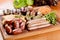 Oktoberfest food menu. Assorted grilled sausages, sauerkraut, green beans on wooden cutting board