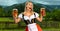 Oktoberfest girl waitress with beer. Woman wearing a traditional Bavarian or german dirndl on octoberfest, serving big