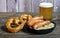 Oktoberfest traditional food. German sausages bratwurst with sauerkraut, beer, and pretzels