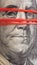 Old 100 dollar bill with Franklin portrait very close up. The banknote is pulled by an elastic band and on the face as if a mask.