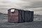 A old abandon railway carriage on Dungeness beach with a black and white background