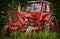 Old abandon red traktor in nature.