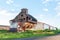 Old abandoned agricultural building with rusty iron walls. Soviet and Russian rural