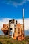 Old abandoned agricultural building with rusty iron walls. Soviet and Russian rural