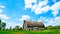 An old abandoned barn sits decaying on an empty farm