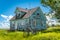 Old, abandoned blue prairie farmhouse in the ghost town of Kayville, Saskatchewan, Canada