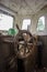 Old abandoned boat, steering wheel from brass and wood. Ship rudder. Sailboat helm