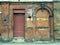 Old abandoned building house shutter and bricked up doorway