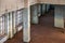 Old abandoned building of the Soviet manufactory. Empty room with columns