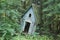 An old abandoned children`s playhouse in the forest.