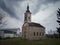 An old abandoned church building in a dilapidated condition against a gloomy sky during the cloudy day