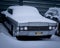 Old, abandoned classic Lincoln Continental car, covered with snow.