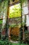 Old abandoned concrete factory structure overtaken by nature / Rusty old ruinous and abandoned building of factory.