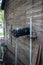 Old Abandoned country mail box with bird nest inside it on the side of a shed