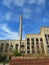 Old abandoned factory with broken windows and bright blue spring sky.