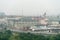 old abandoned factory building in the middle of a green forest. Panorama of the city with a view of factories and enterprises.