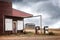 Old abandoned gas station with two broken gas pumps