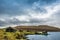 An old abandoned hamlet in the Faroe Islands. Mountains and lake on background