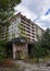 Old abandoned hotel situated in a tranquil wooded area near another building in Chernobyl