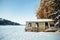 Old abandoned house nearby frozen lake