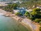 old abandoned house with pool on the beach overgrown with palm trees and plants, lost places, tarragona spain