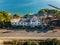 old abandoned house with pool on the beach overgrown with palm trees and plants, lost places, tarragona spain