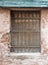 Old abandoned house window with heavy rusted metal bars