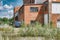 An old abandoned industrial site with a red brick building with a rusty van on it