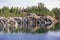 Old abandoned marble quarry filled with water on a summer sunny day. Russia.