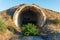 An old abandoned military tunnel, a semicircle of concrete inside a hill