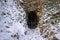 Old abandoned mine entrance barred to protect bats living inside it in snow