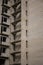 An old abandoned multistorey building made of white silicate brick. Disassembled wooden windows. Broken interstory steps