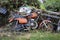 Old abandoned orange motorcycle