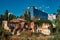 Old abandoned overgrown ruined house on modern building   background, Voronezh, Russia. Contrast and time concept