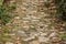Old abandoned paved textured stone road in park outdoor garden environment space wallpaper background pattern in perspective