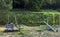 Old, abandoned playground, without children, swing, carousel, sandbox.