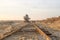 Old abandoned railway track. Rusty railroad tie. Giant stacker. Bucket chain excavator in a sand quarry. Bulk material handling