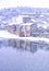 Old and abandoned river mill in a strong white snow next to reflected river, Europe 