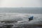 An old abandoned rowboat in shallow water