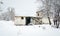 Old abandoned ruin house without windows and roof used as homeless shelter during the summer empty on the cold winter days with sn