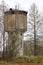 Old abandoned ruined water tower in the forest