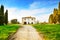 Old abandoned rural house, road and trees on sunset.Tuscany, Italy