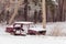 Old abandoned.Rusty, destroyed, abandoned car in the countryside of Ukraine on a winter day