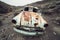 OLd abandoned rusty retro car in the desert with bullet holes in metal.