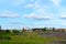 An old abandoned sawmill stands in the village on an empty field with a shed with a failed roof