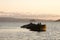 Old abandoned skeleton of a wooden ship half sunken in the sea