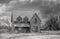 An old abandoned spooky house in spring on a farm yard in rural Canada