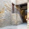 Old abandoned staircase with wooden balustrade and wooden door at stone bricks passage, Cairo, Egypt